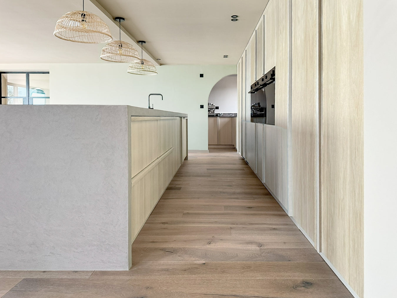 Modern kitchen with wooden flooring and white washed oak cabinets