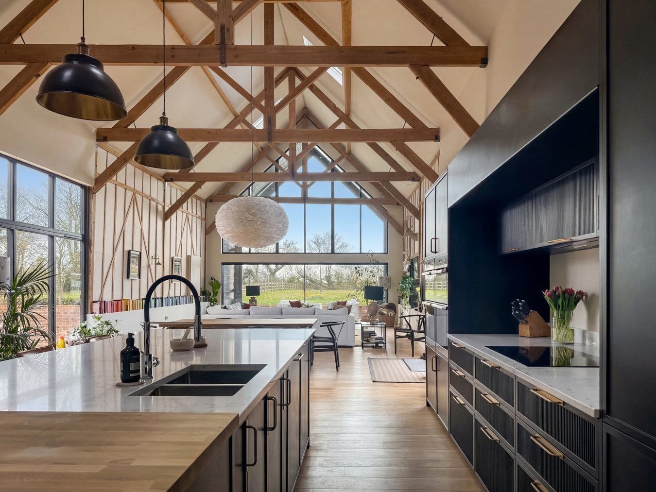Grand Desgin featured kitchen with wooden beams and large windows