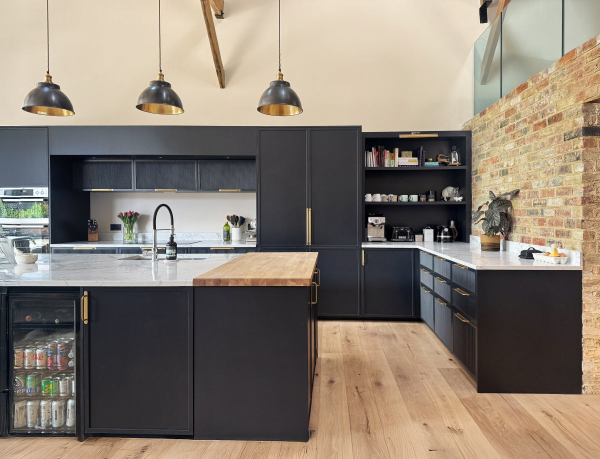 Modern kitchen with slimlien shaker cabinets, reeded shaker kitchen island, and brick wall.