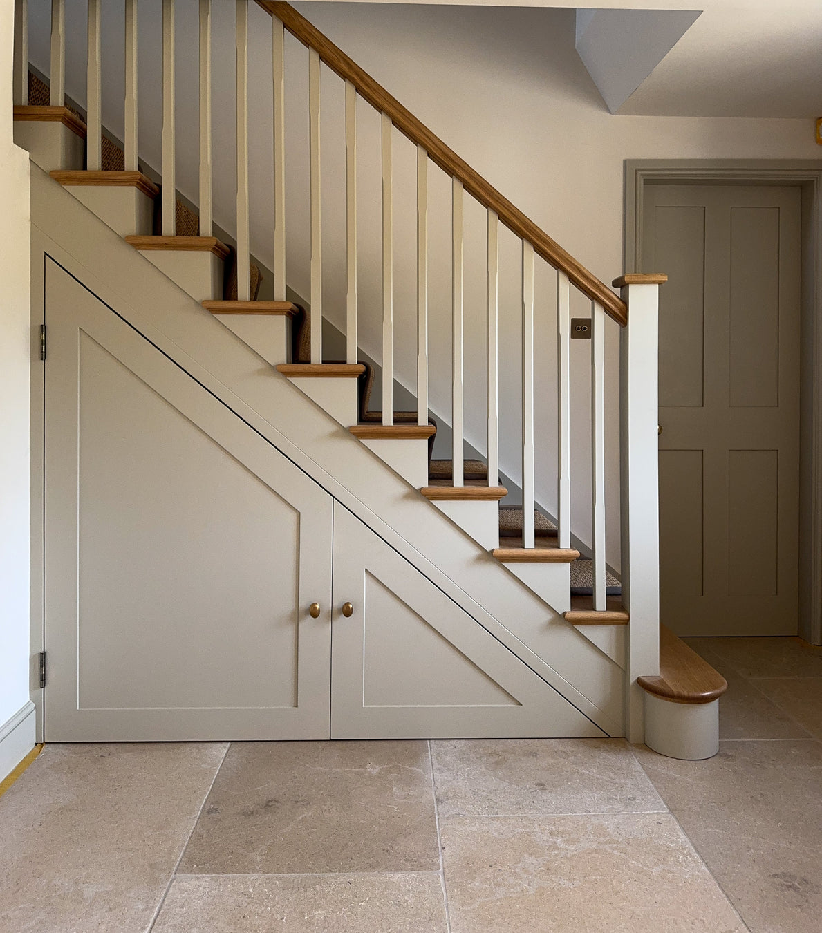Staircase with wooden steps and white railings in a home interior.