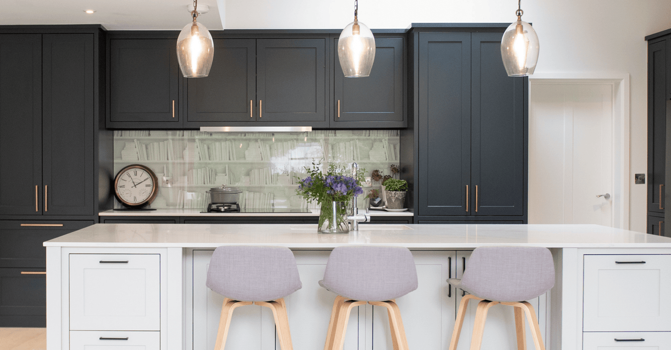 Inframe shaker kitchen with two tone colours and gray stools.