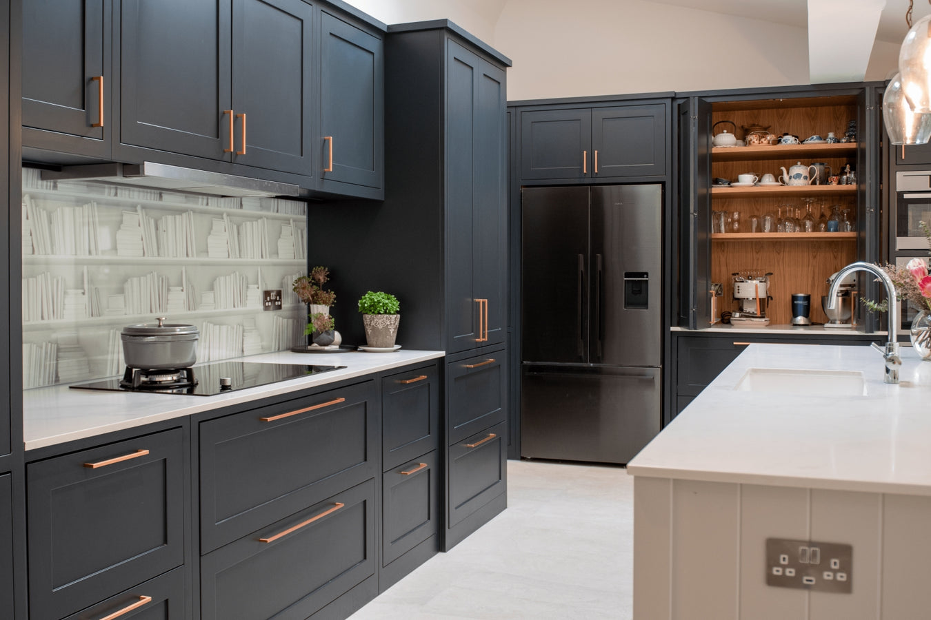 Inframe shaker kitchen cabinets, stainless steel appliances, and a light-colored floor.