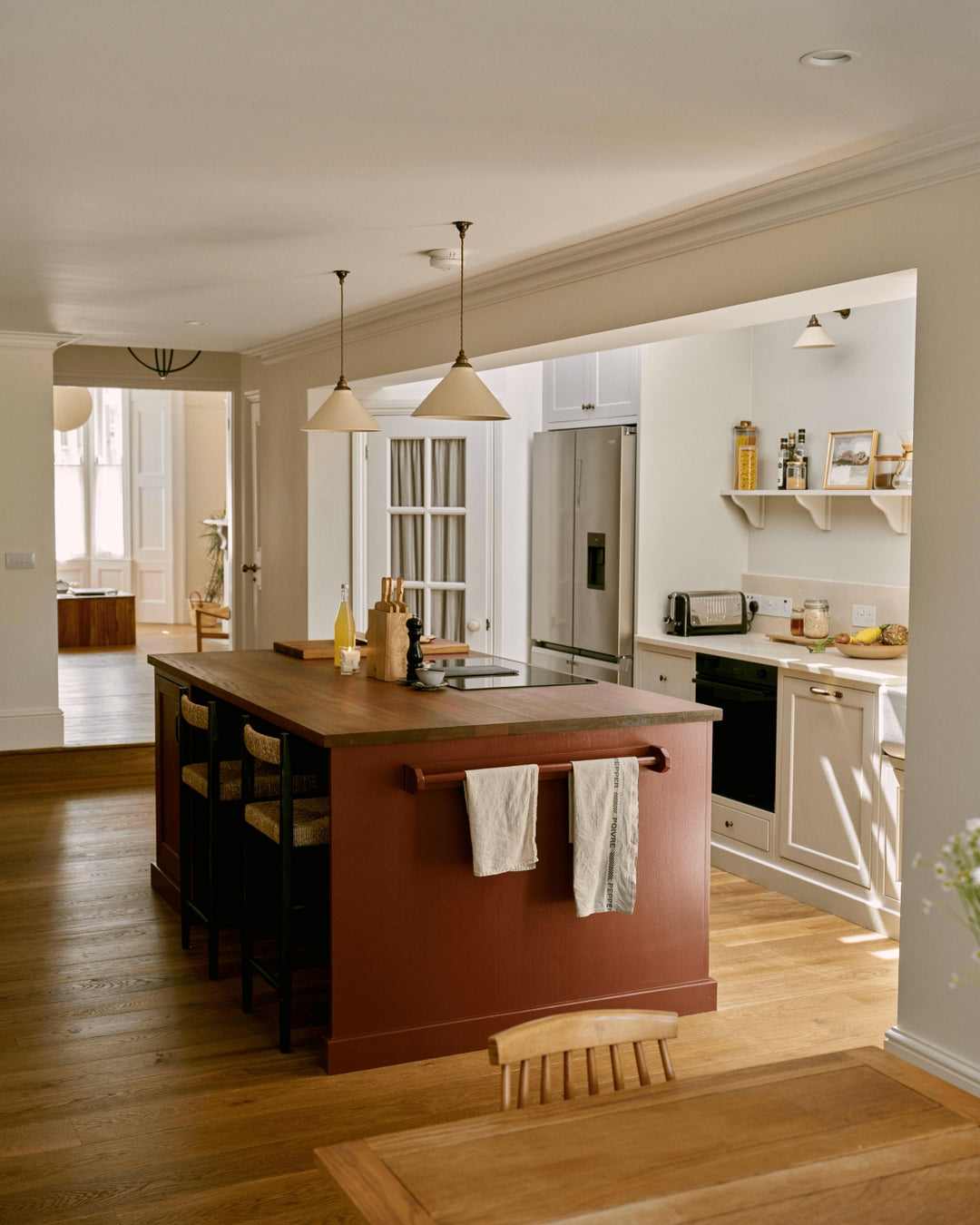 Modern kitchen with burgandy shaker kitchen island and stainless steel appliances