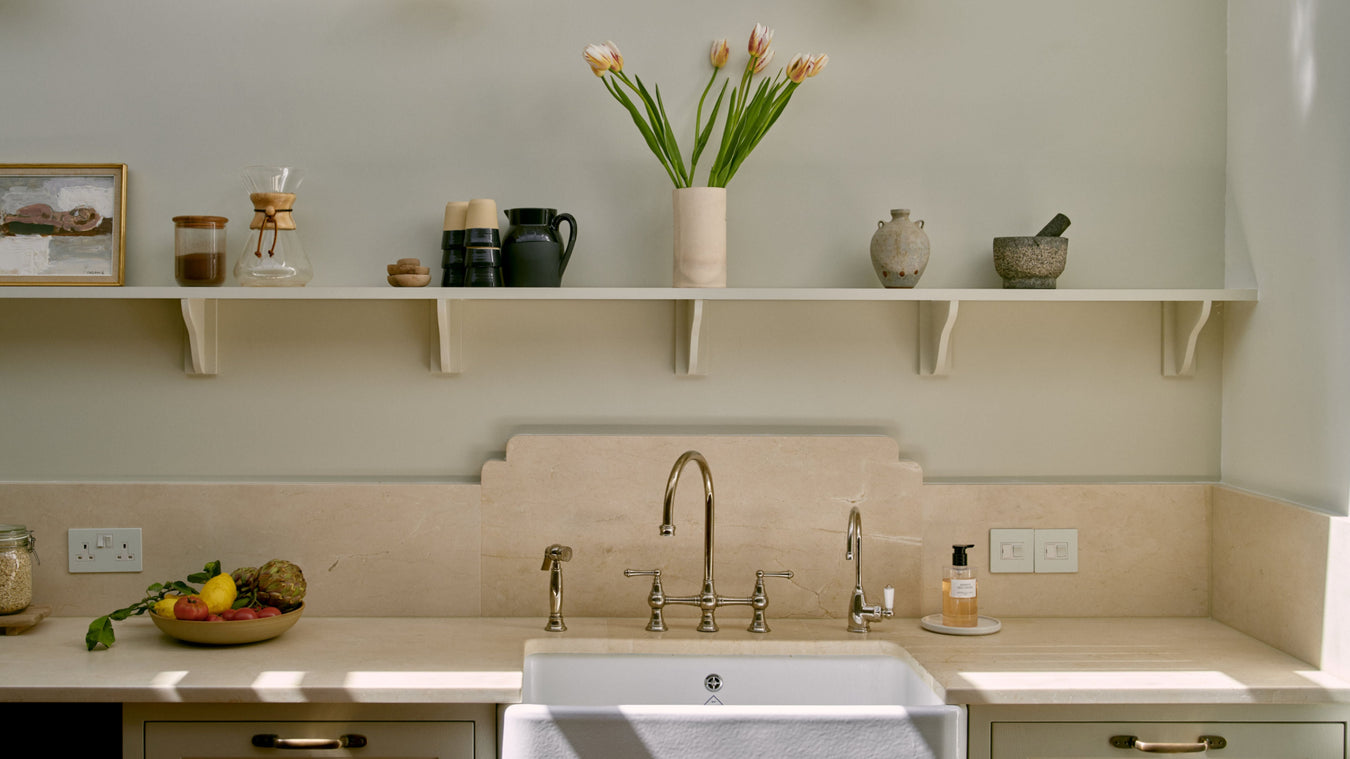 Shaker Kitchen with a sink, worktop, and shelves with decorative items.