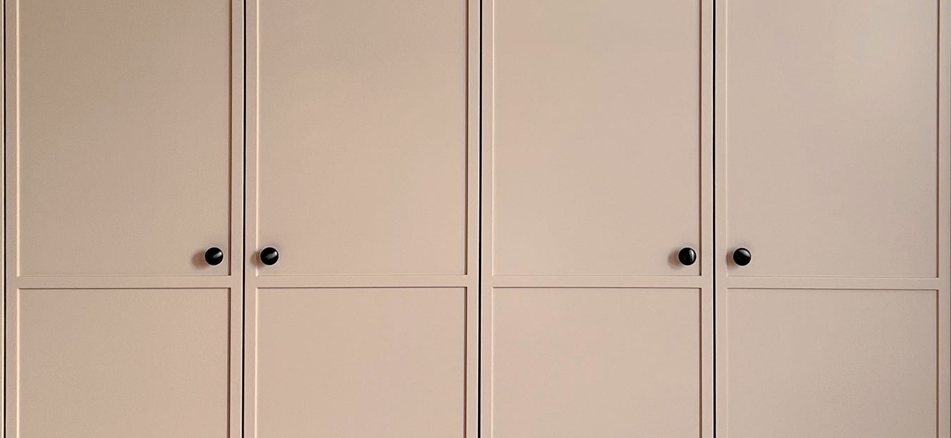 Slimline shaker wardrobe with four doors and small black knobs.